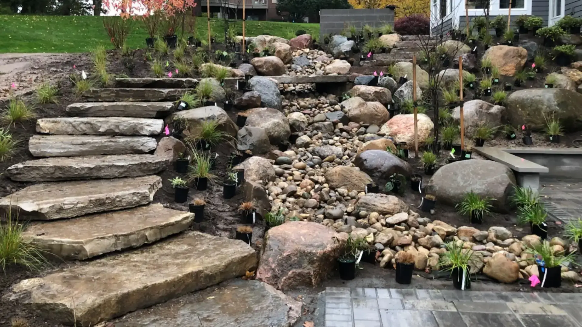 Landscape design Grand Rapids featuring a custom front yard with manicured lawn, layered planting, and a welcoming residential approach