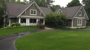 Landscape design process in Grand Rapids showing a finished residential landscape with clean lawn lines, foundation plantings, and a polished front approach