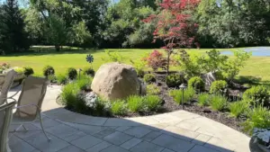 How much are landscape design services shown through a custom residential landscape with patio, planting beds, and value-driven outdoor improvements