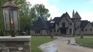 front yard landscape design Grand Rapids with curved driveway, manicured lawn, layered foundation planting, and strong curb appeal