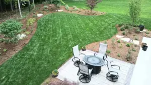 How to plan an outdoor living space in Michigan with patio dining area, defined paving, privacy wall, and structured planting