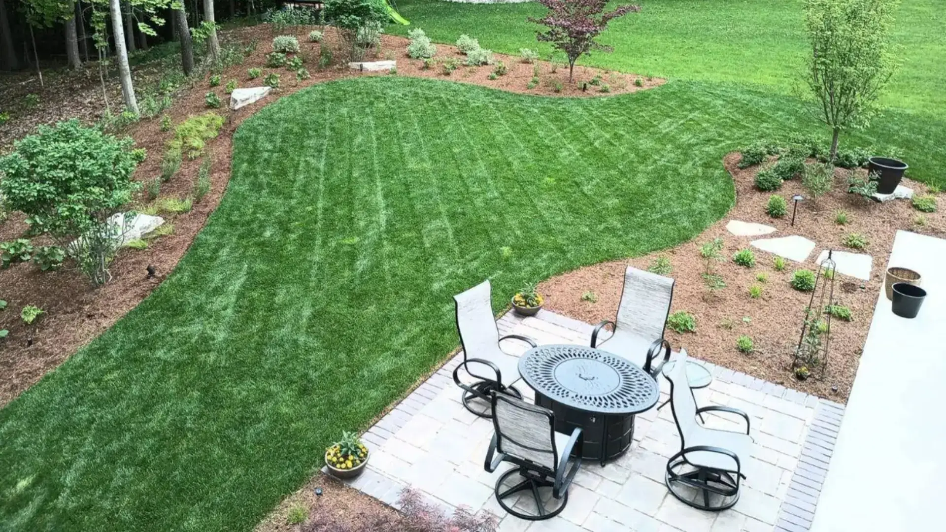 How to plan an outdoor living space in Michigan with patio dining area, defined paving, privacy wall, and structured planting