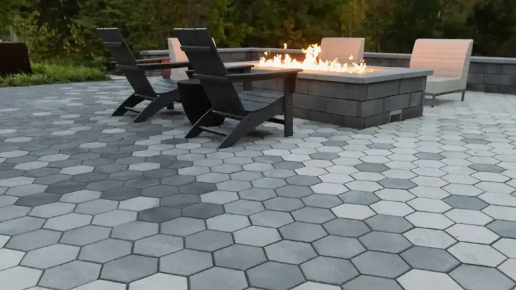 Patio and outdoor living design Grand Rapids with large paver patio, fire feature, and lounge seating for entertaining outdoors